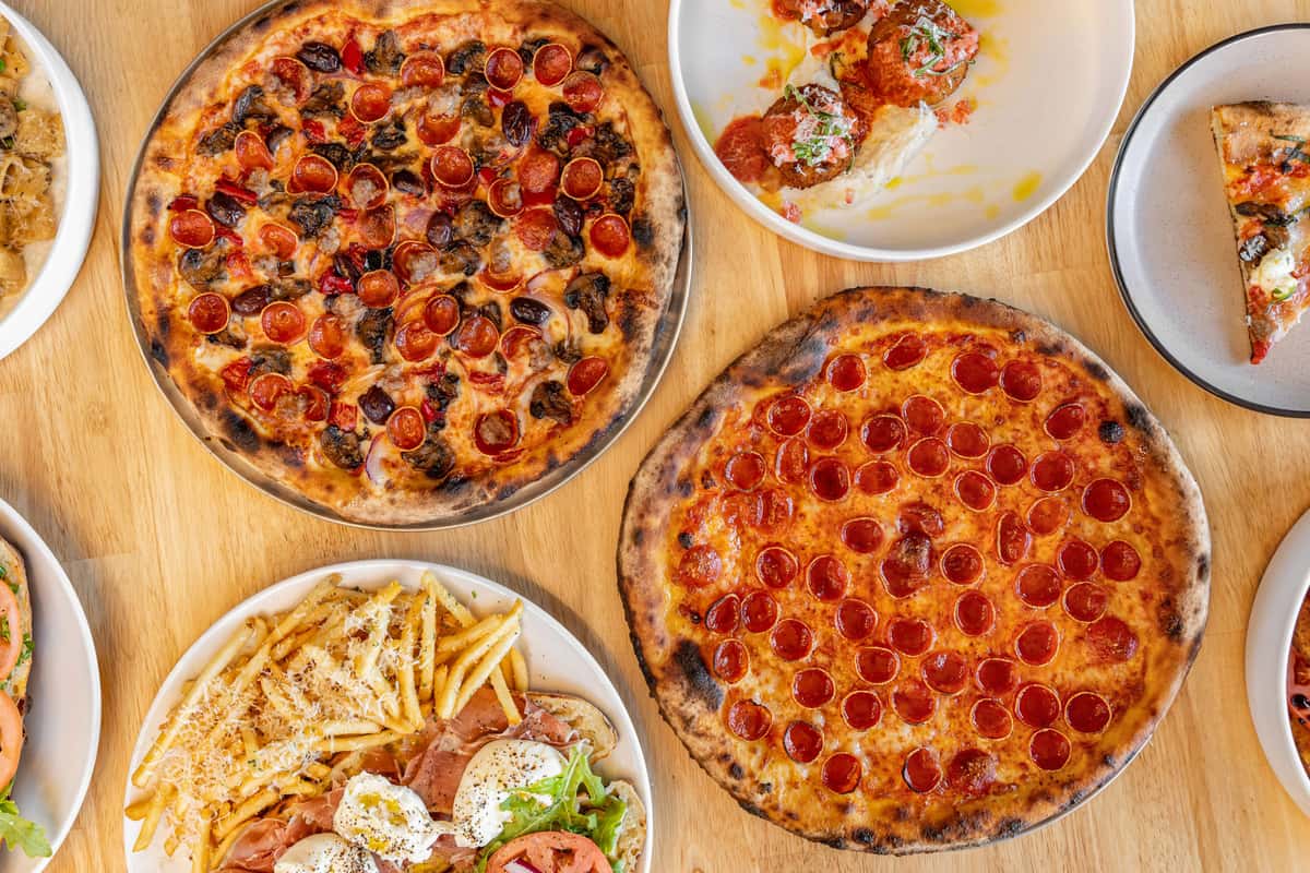 Pizzas and salad with fries and more