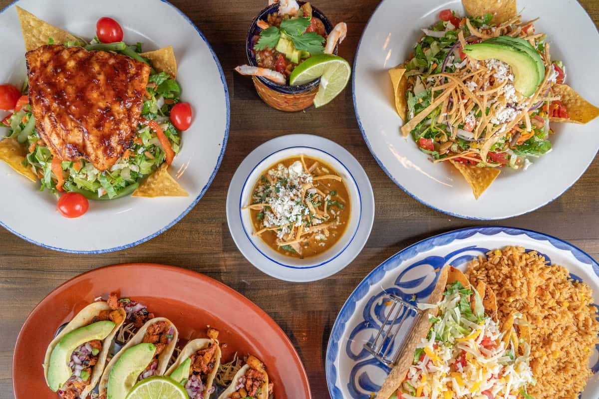 Mexican dishes and drinks spread out on a table