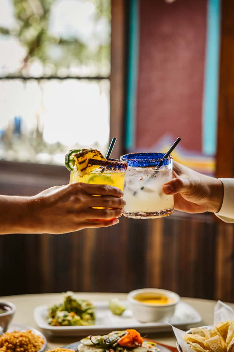 Two hands cheering drinks