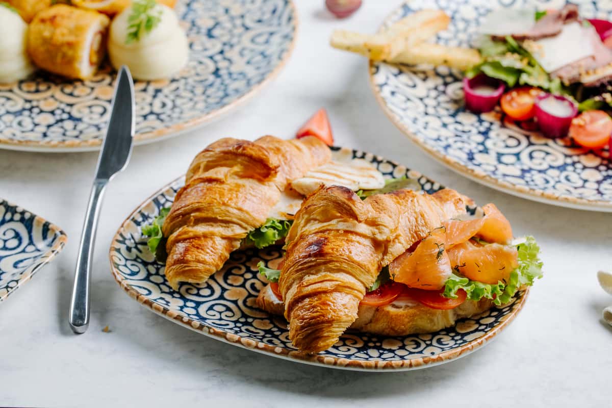 Croissant with lettuce tomato and salmon