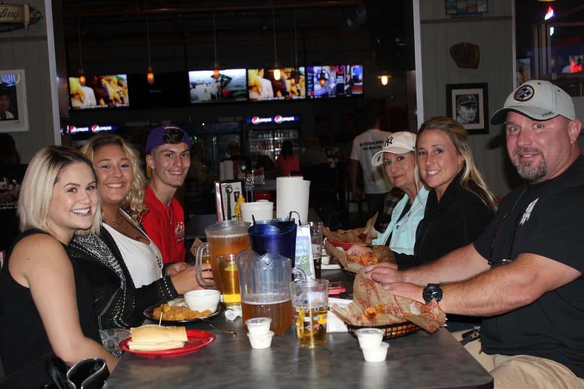 group of 6 people smiling at table
