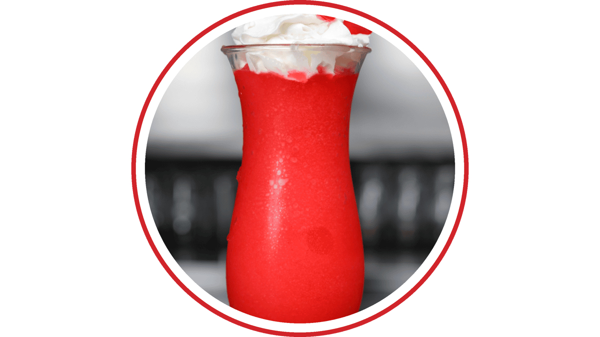 Frozen Swedish Fish dessert cocktail topped with whipped cream in a tall glass.
