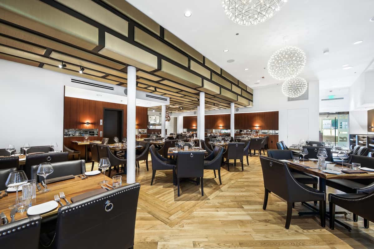 Silo Prime's dining room with tables, chairs and chandeliers