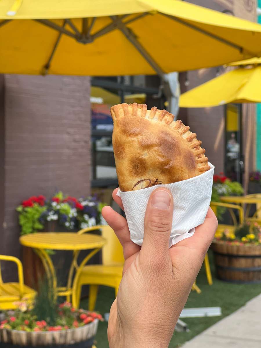 closeup of hand holding empanada