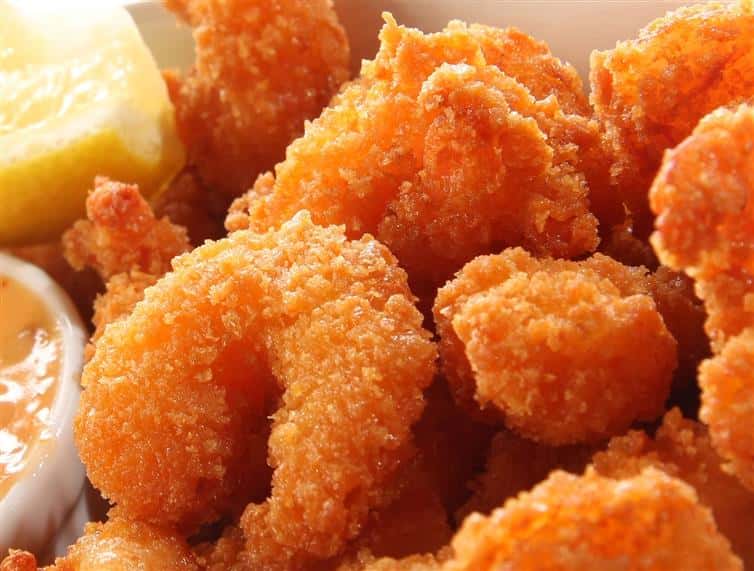 fried shrimp with a lemon wedge and side of dipping sauce