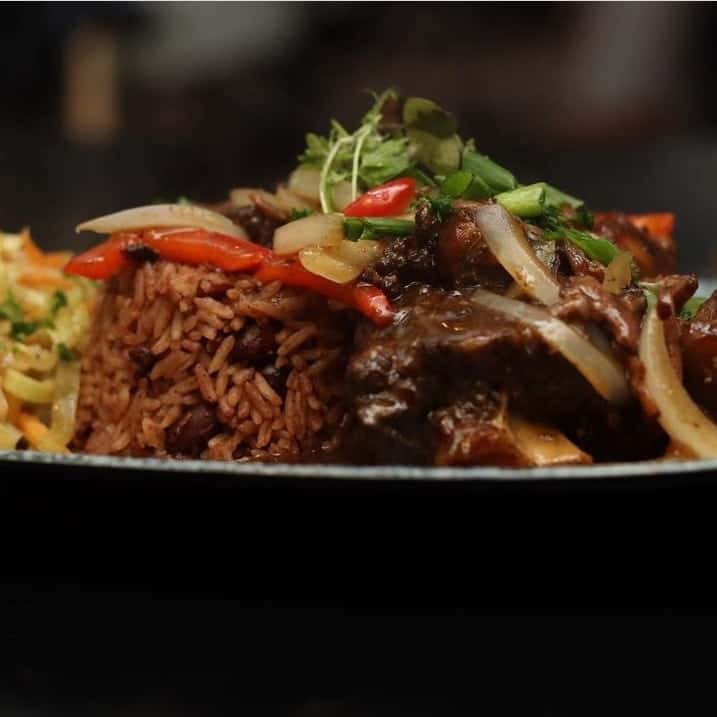 Braised oxtail cooked in spices, rice n peas, and steamed cabbage.