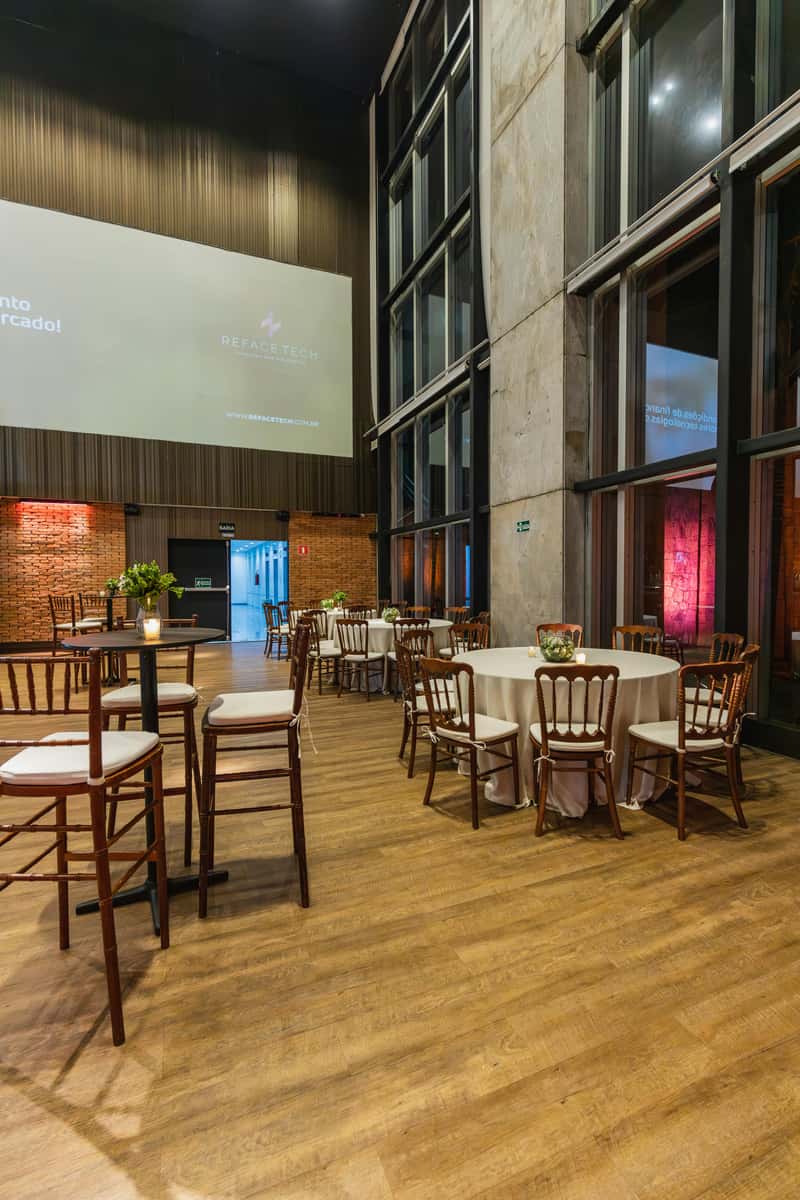 The interior of a venue is prepared with tables and chairs, similar to a private event space possibly related to Spot Gourmet Burgers.