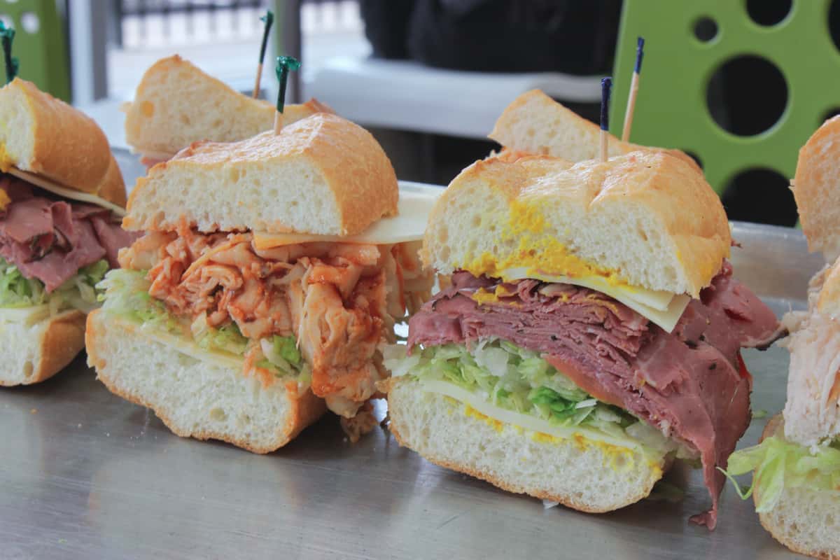 a sandwich, a pickle, and chips
