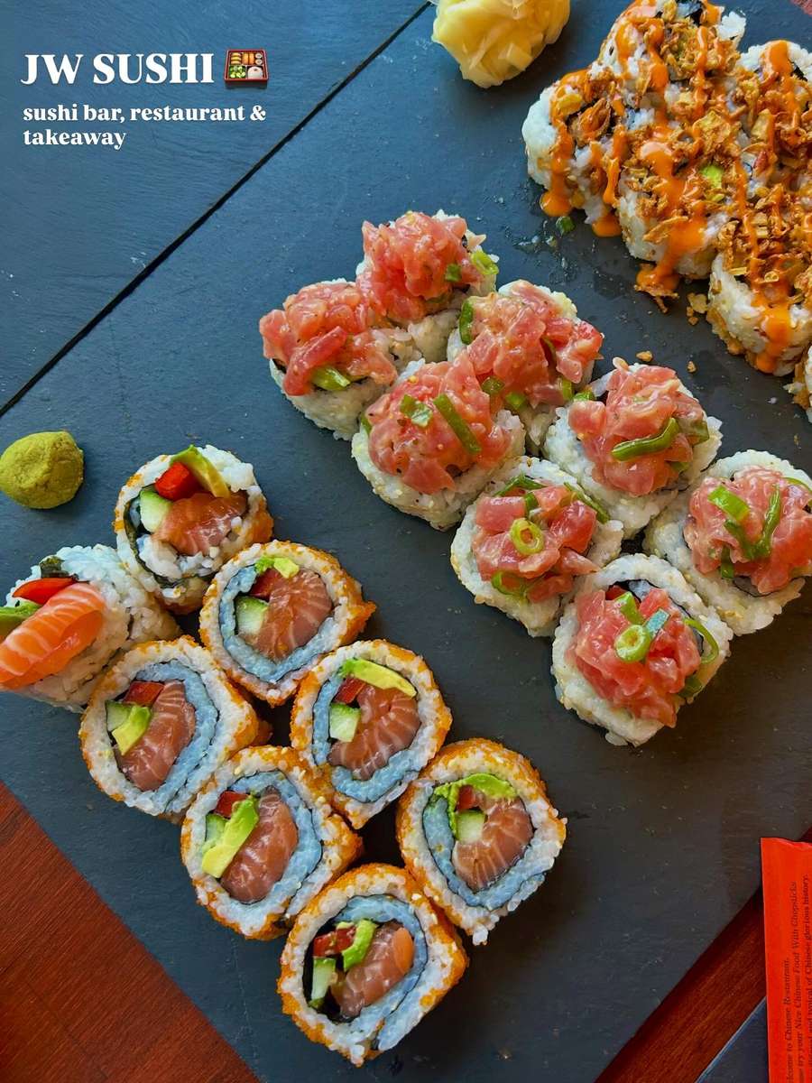 Sushi laid out on black tables