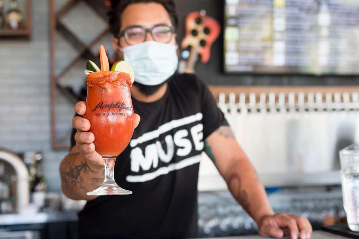 employee holding bloody mary