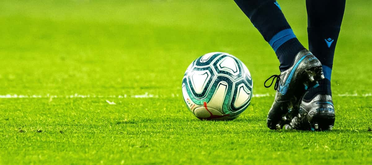 Soccer player on a field playing with a soccer ball