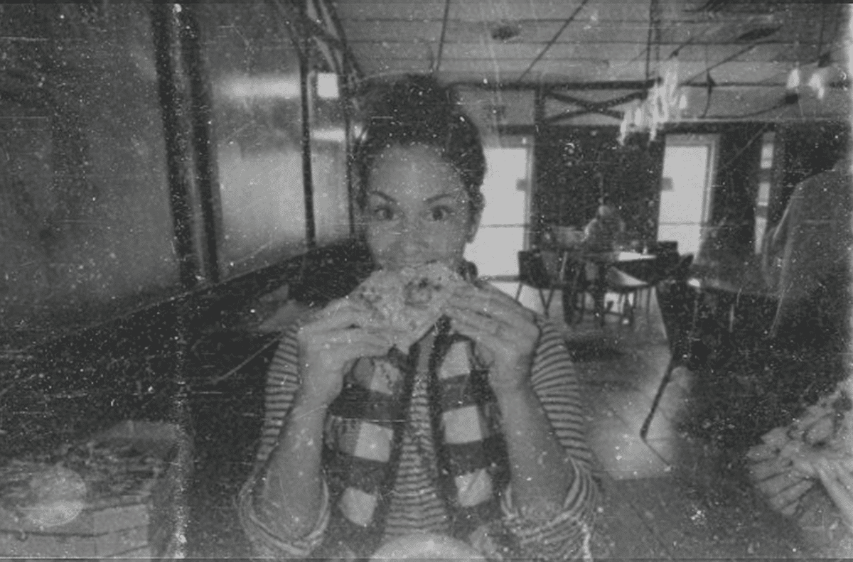 Happy customer enjoying a slice of pizza