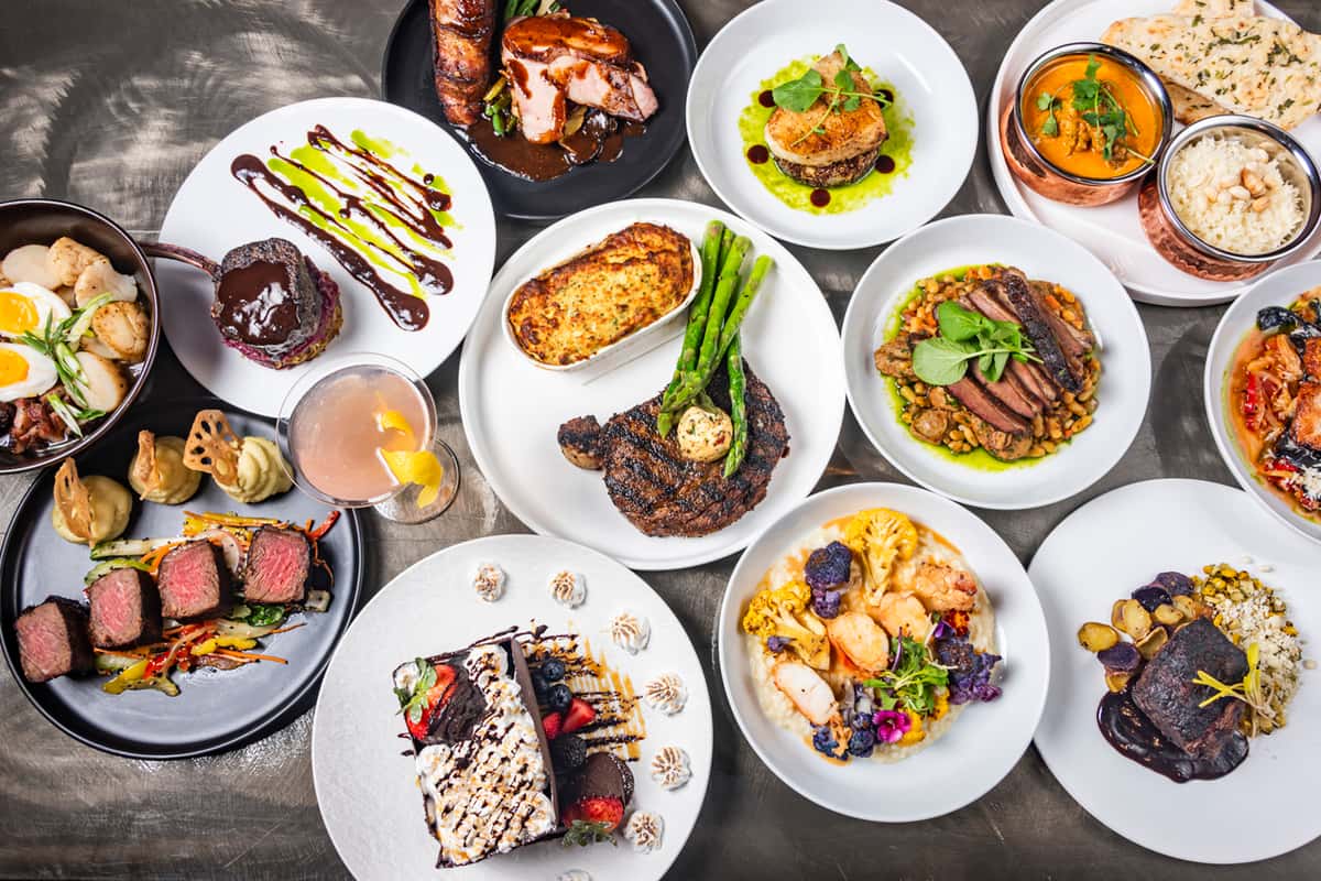 spread of food with steak, asparagus, salads and more