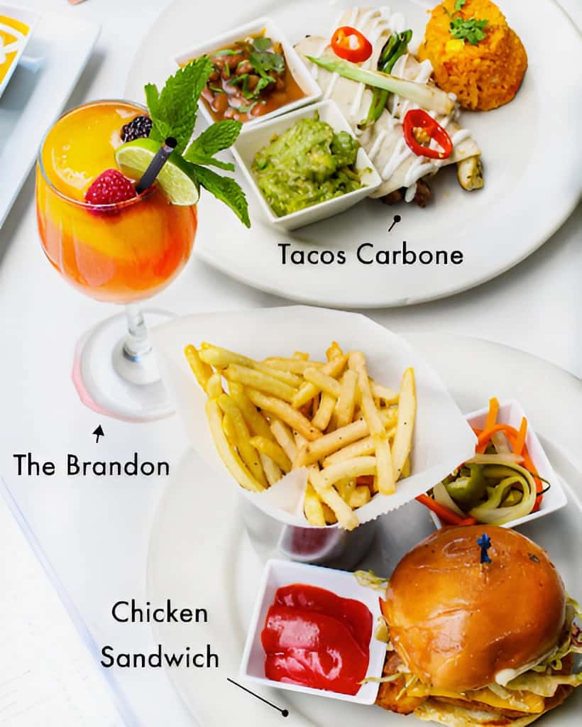 Mesero casual lunch with The Brandon cocktail, Chicken Sandwich and fries, and Tacos Carbone for a balanced midday meal.