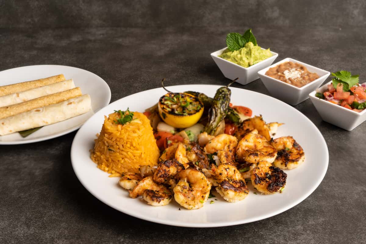 Mesero grilled shrimp fajita platter with rice, tortillas, guacamole, beans, and pico de gallo.
