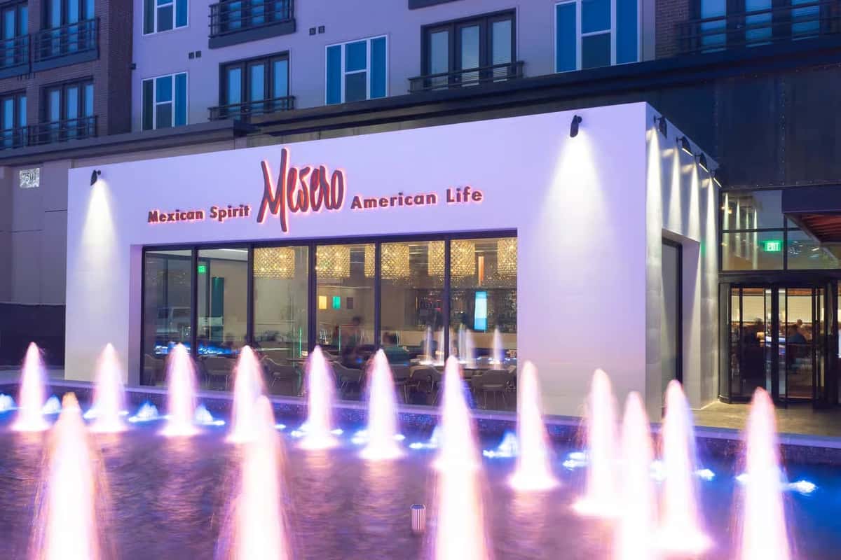 Mesero Mexican Spirit American Life restaurant exterior with fountain and illuminated storefront.
