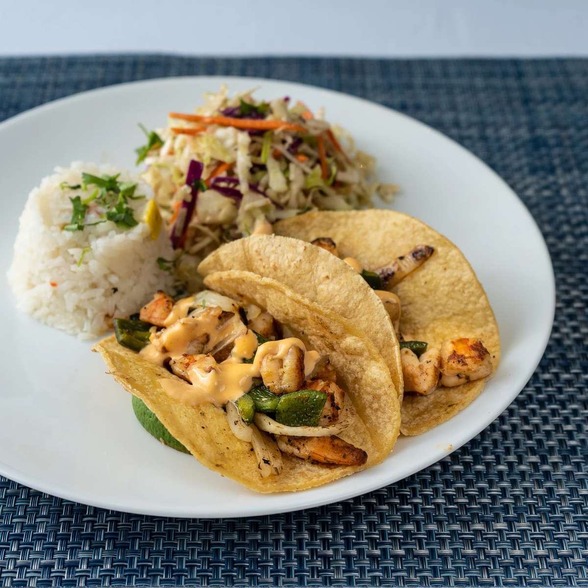 Mesero tacos with rice and sides showcasing menu variety for business lunch guests.