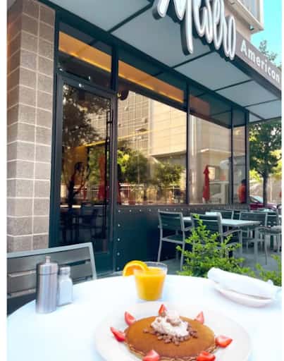 Fresh strawberry pancakes and orange juice set the scene for brunch on the Mesero patio.