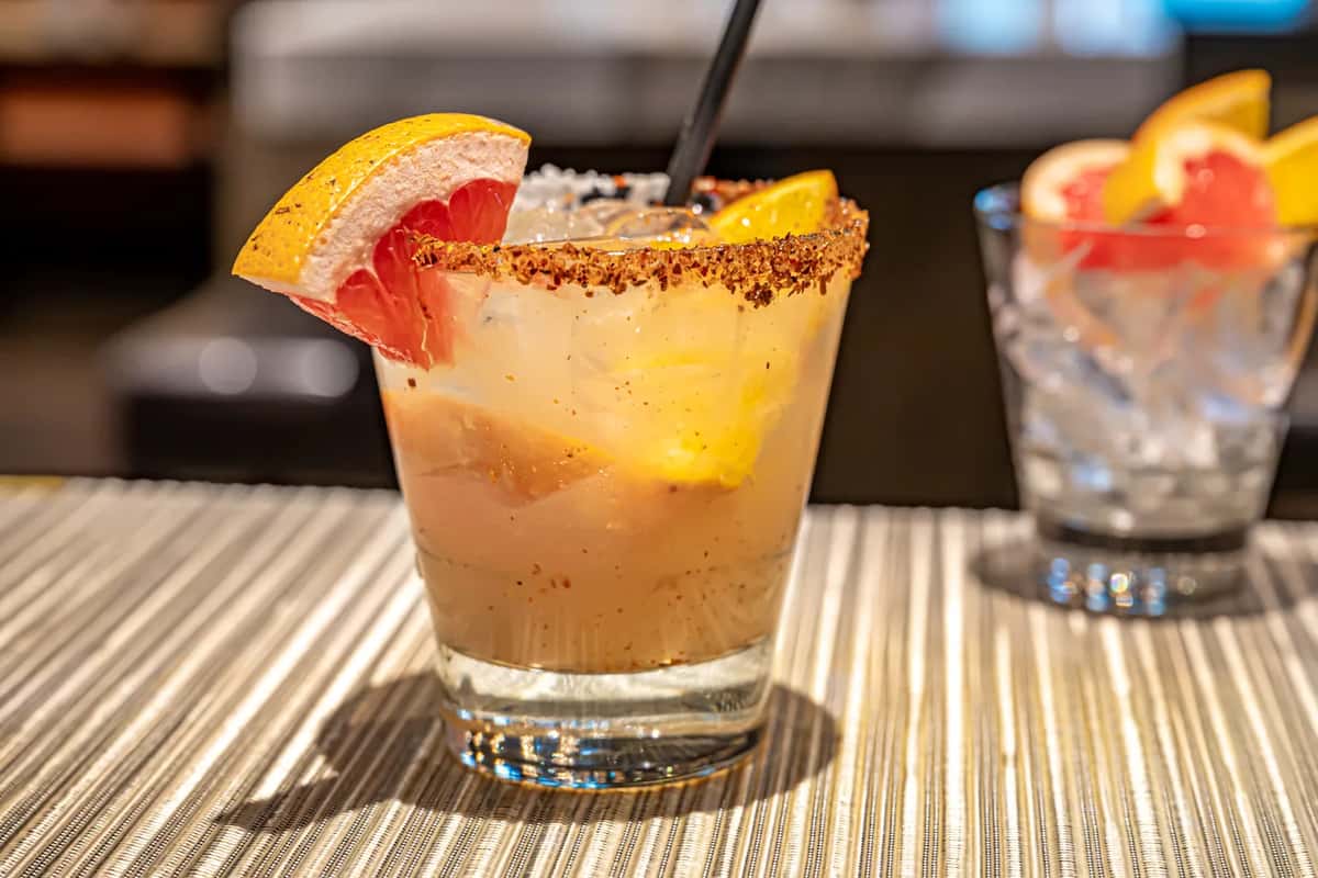 Mesero’s refreshing cocktail served in a short glass with a chili-salt rim, garnished with a wedge of grapefruit and orange.