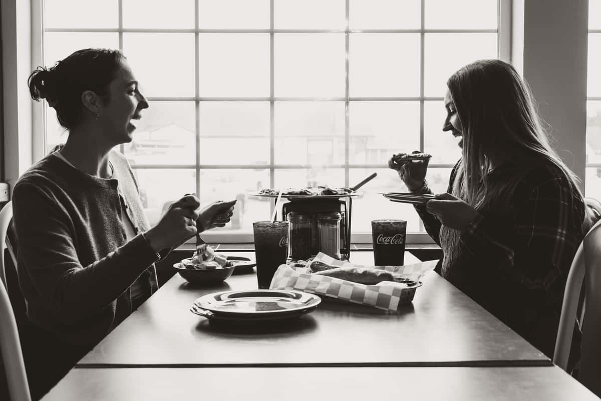 black and white photo of friends eating
