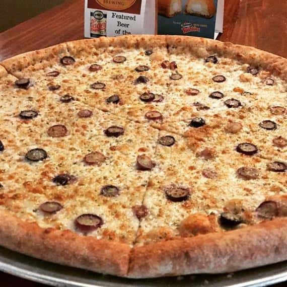 Cheese pizza on a tray with sliced olives