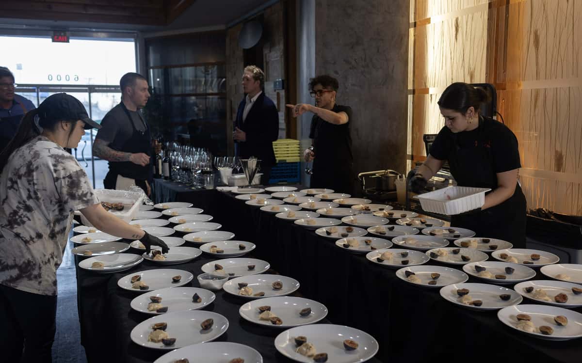The kitchen team plating a course during the Staglin wine dinner at 360 Bistro Nashville