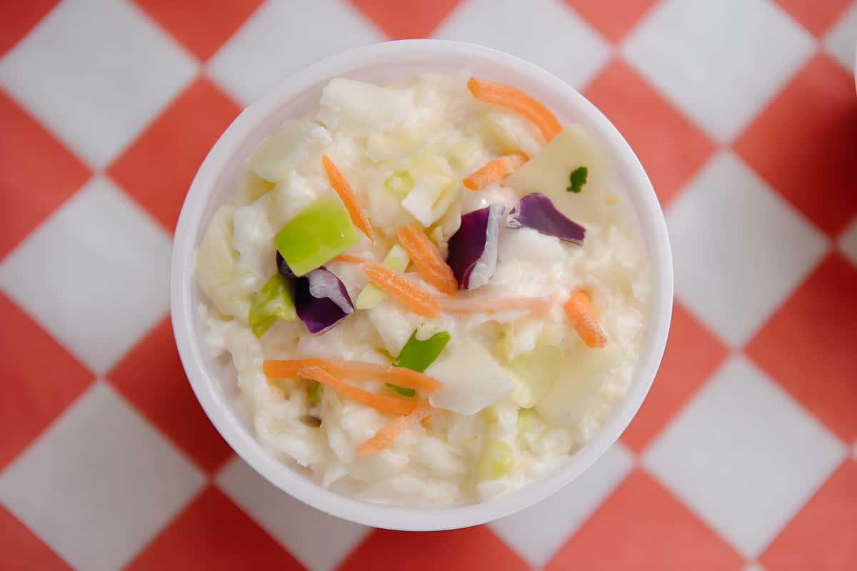 Fresh creamy coleslaw made with cabbage, carrots, and vegetables.