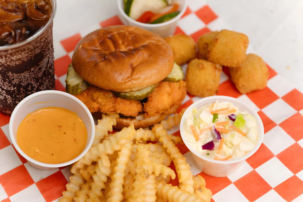 Crispy chicken sandwich served with crinkle cut fries, hush puppies, coleslaw, and dipping sauce.