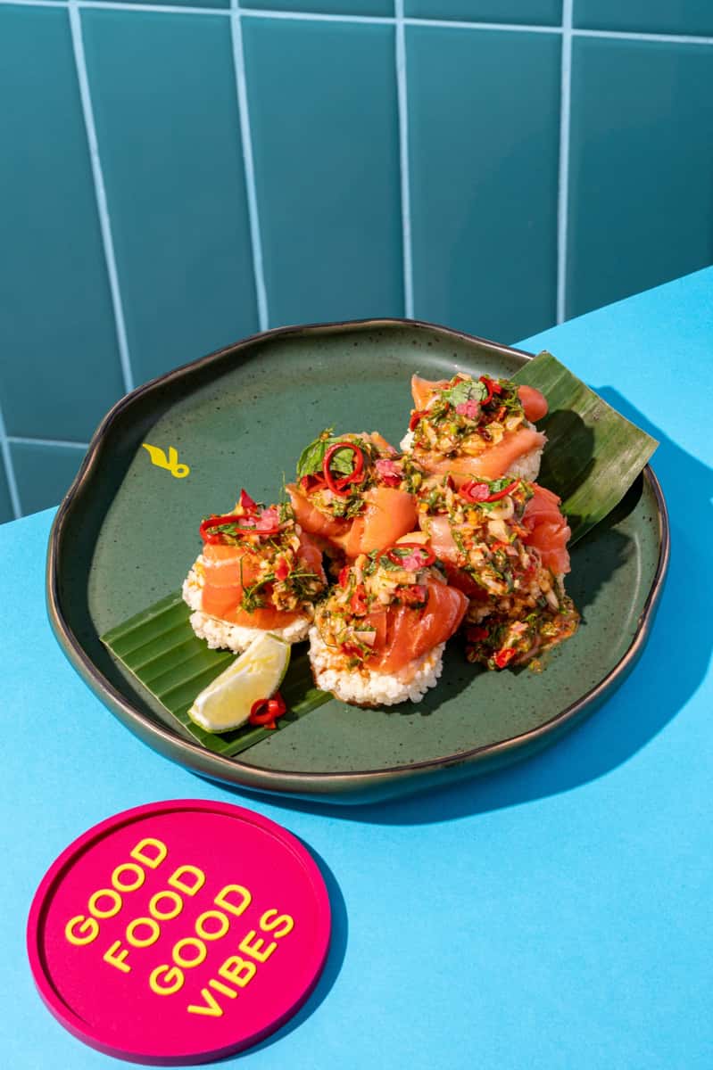Thai salmon larb with fresh chilli, herbs and lime on a banana leaf