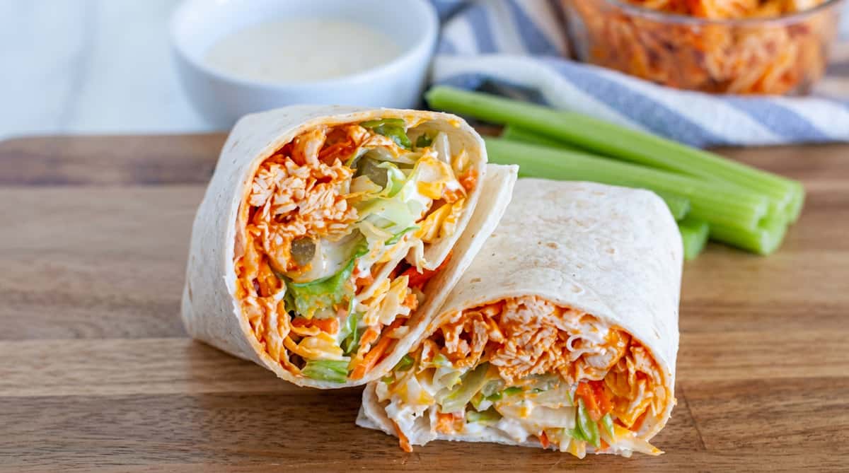 Buffalo chicken wrap filled with shredded buffalo chicken, crisp lettuce, shredded cheese, and creamy ranch dressing, served in a soft flour tortilla.