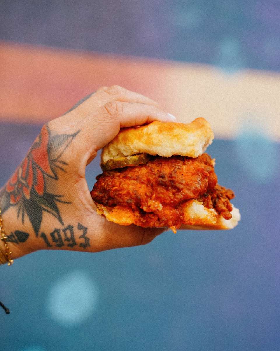 Hand holding a chicken biscuit sandwich