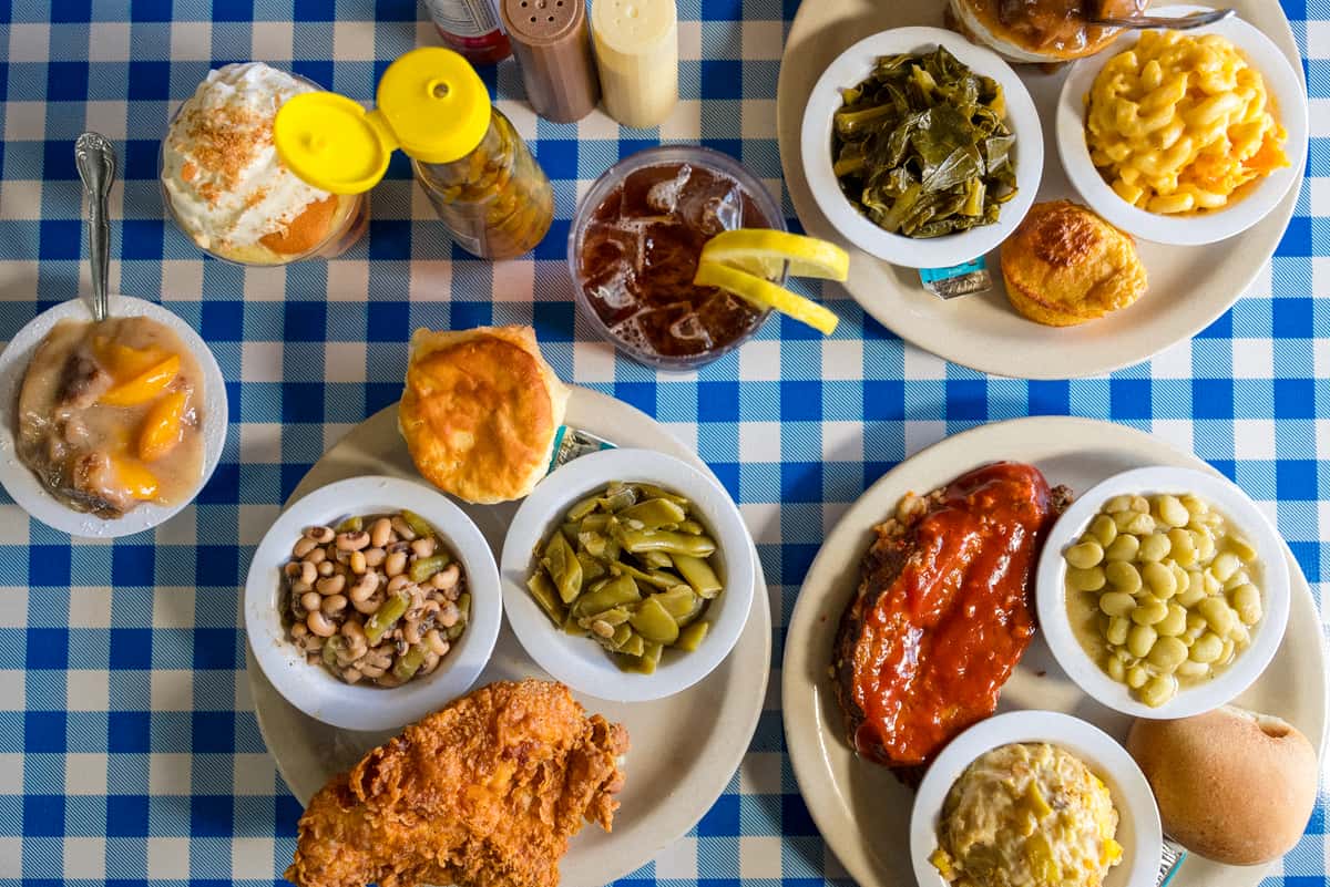 Southern comfort foods, fried chicken, meatloaf and sides on a table