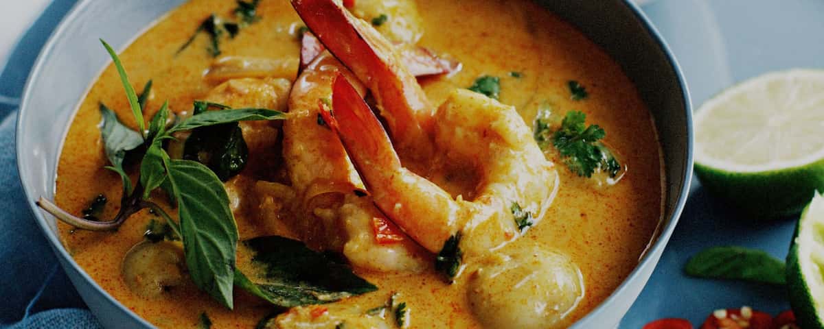 Prawn curry cooking in a saucy pot