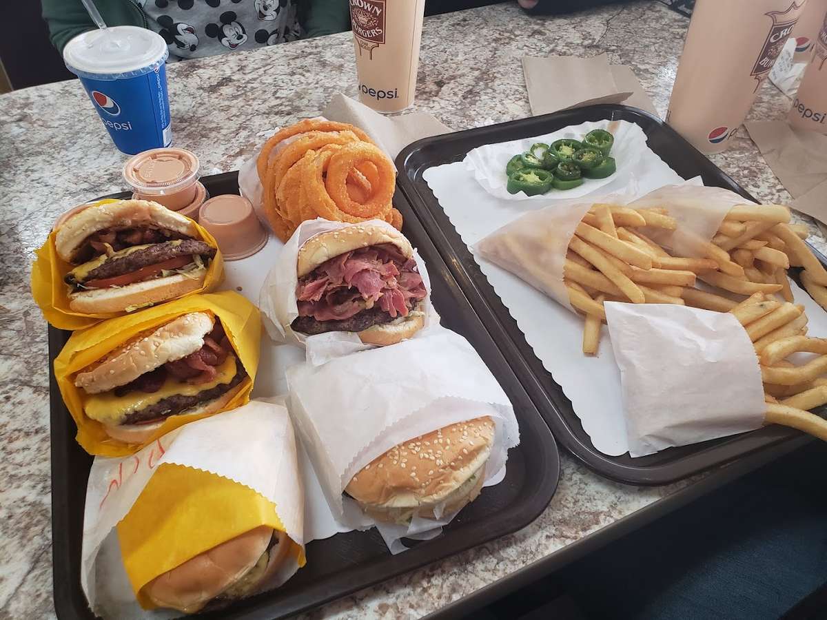 trays of burgers, fries, and onion rings