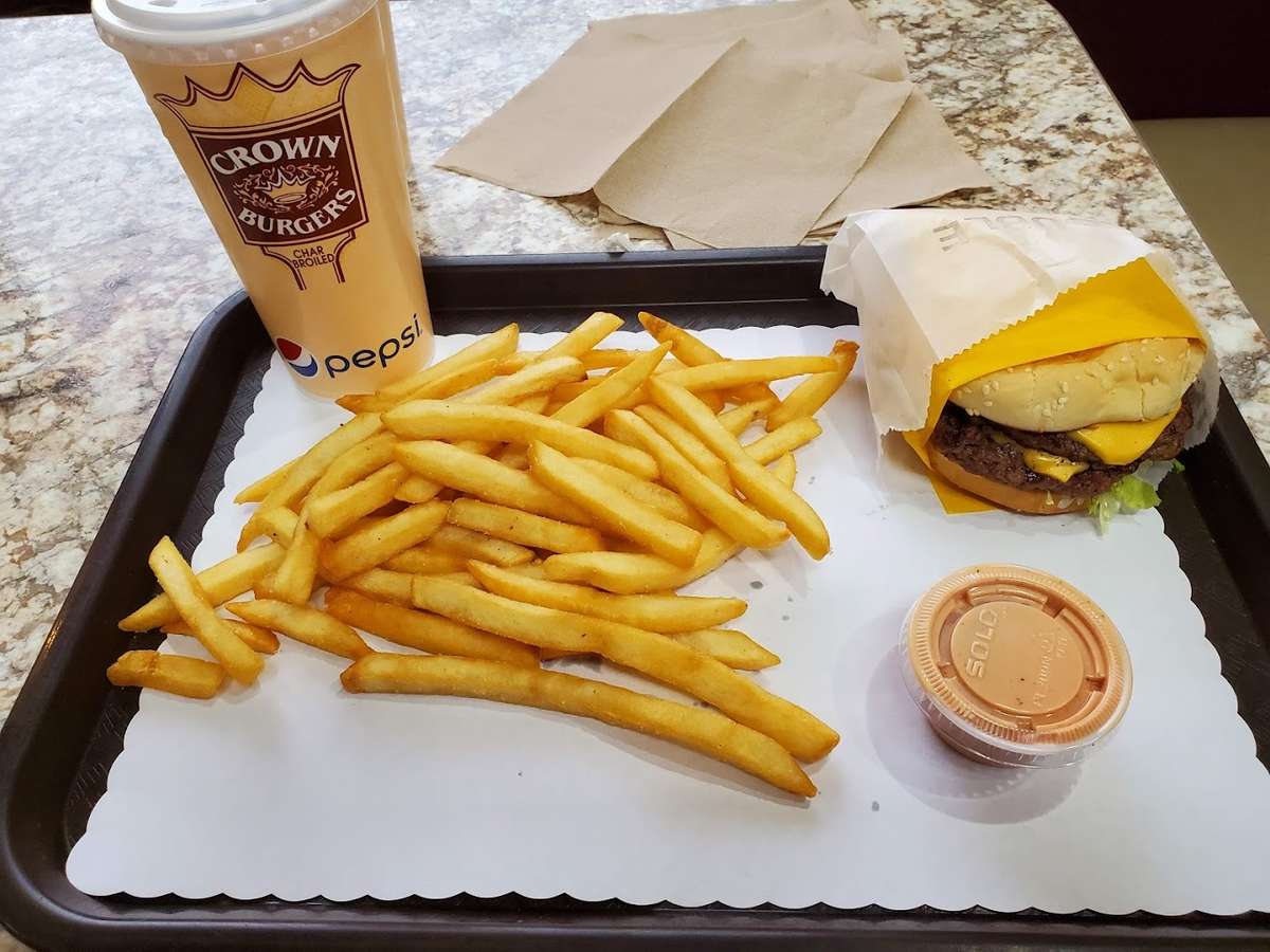 french fries, burger, and drink on tray
