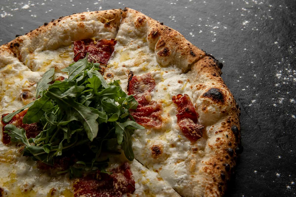 Mozzarella, Ricotta, Speck, Garlic, Lemon Zest, Arugula, Extra Virgin Olive Oil
Note: Speck Is A Thinly Sliced Cured, Lightly Smoked Italian Ham 
Allergens: Dairy, Gluten