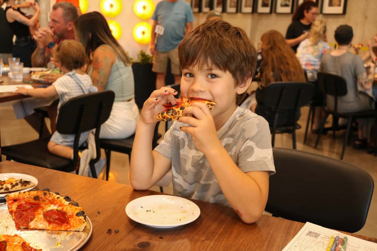 kid eating pizza