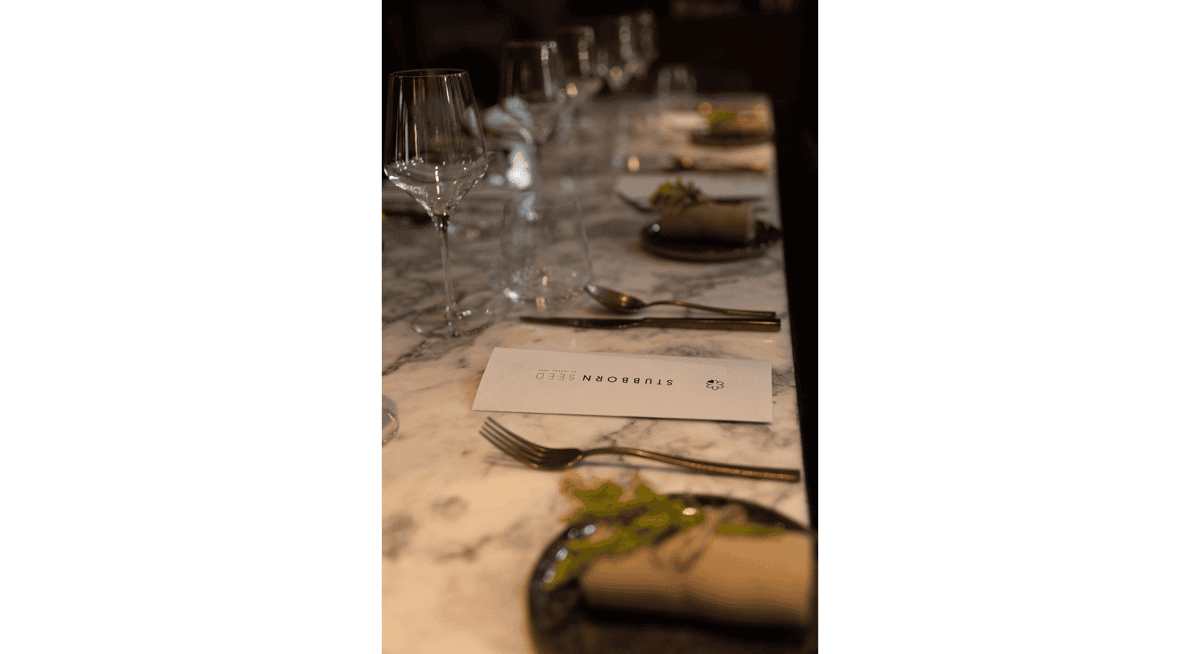 Elegant Michelin-star plated dish in a modern Miami restaurant setting.