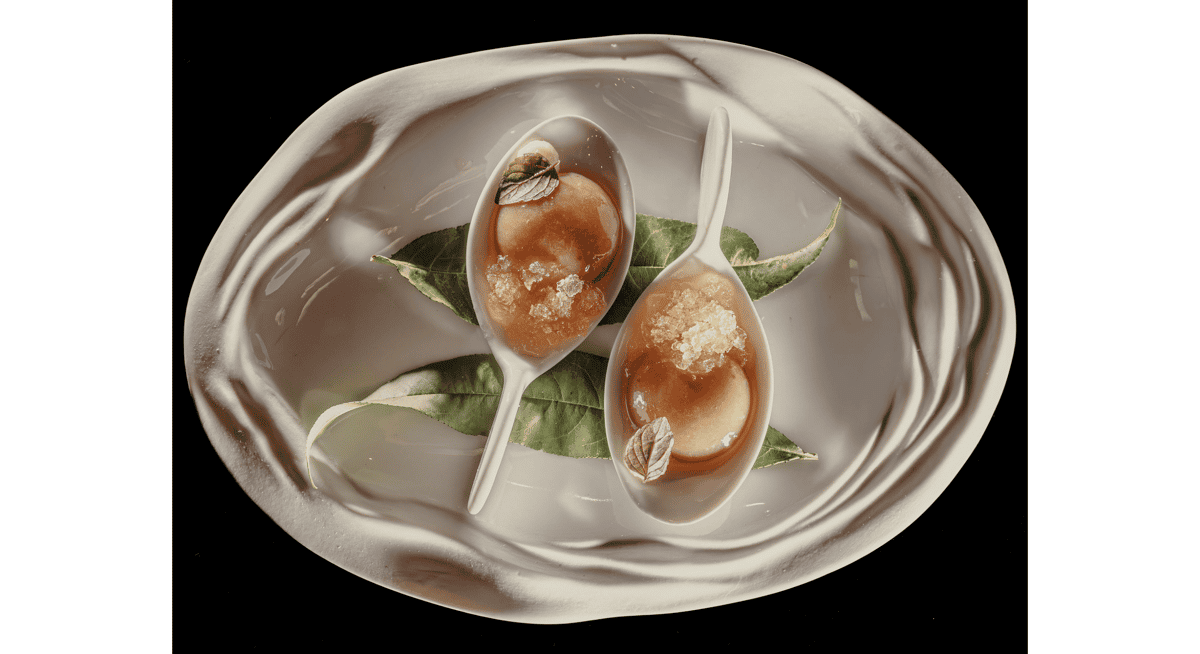 Artfully plated fine dining dessert served in elegant ceramic spoons with delicate garnish, demonstrating Michelin-star level presentation and detail.