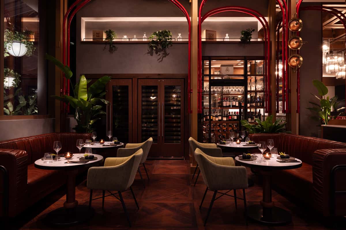Upscale Stubborn Seed Las Vegas dining room with leather booths and warm lighting