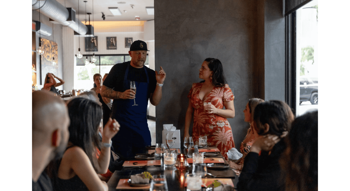 Chef speaking to guests during an intimate tasting experience at Stubborn Seed, reflecting the creativity and precision behind Michelin-star menu design.