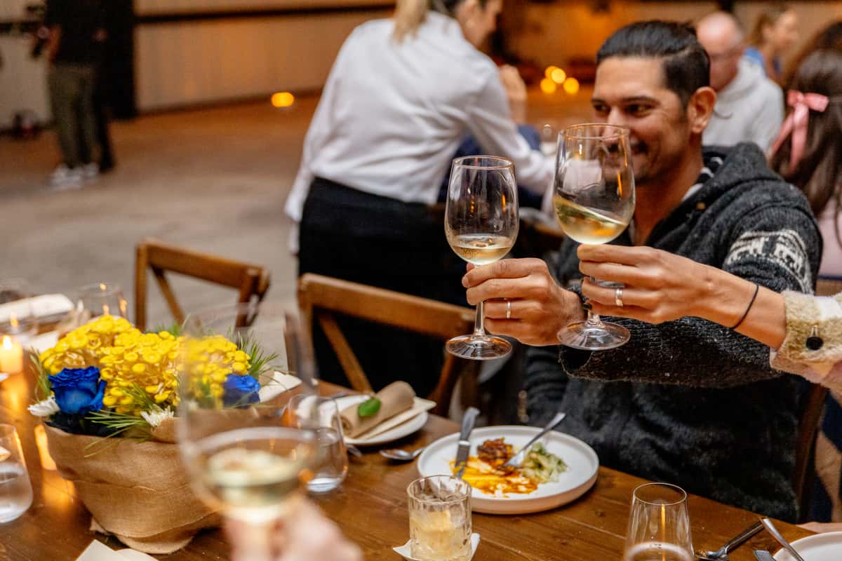 Diners toasting with wine during an upscale restaurant service experience
