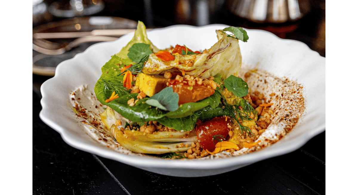 Artfully plated vegetable dish with vibrant garnishes and modern presentation, reflecting the innovation and creativity of Michelin-star dining.