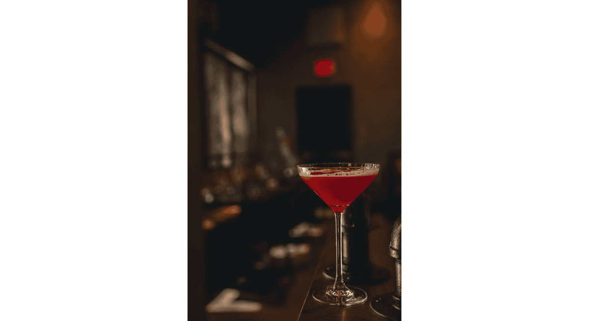 Elegant red wine or cocktail served in a stemmed glass during an upscale fine dining wine pairing experience.