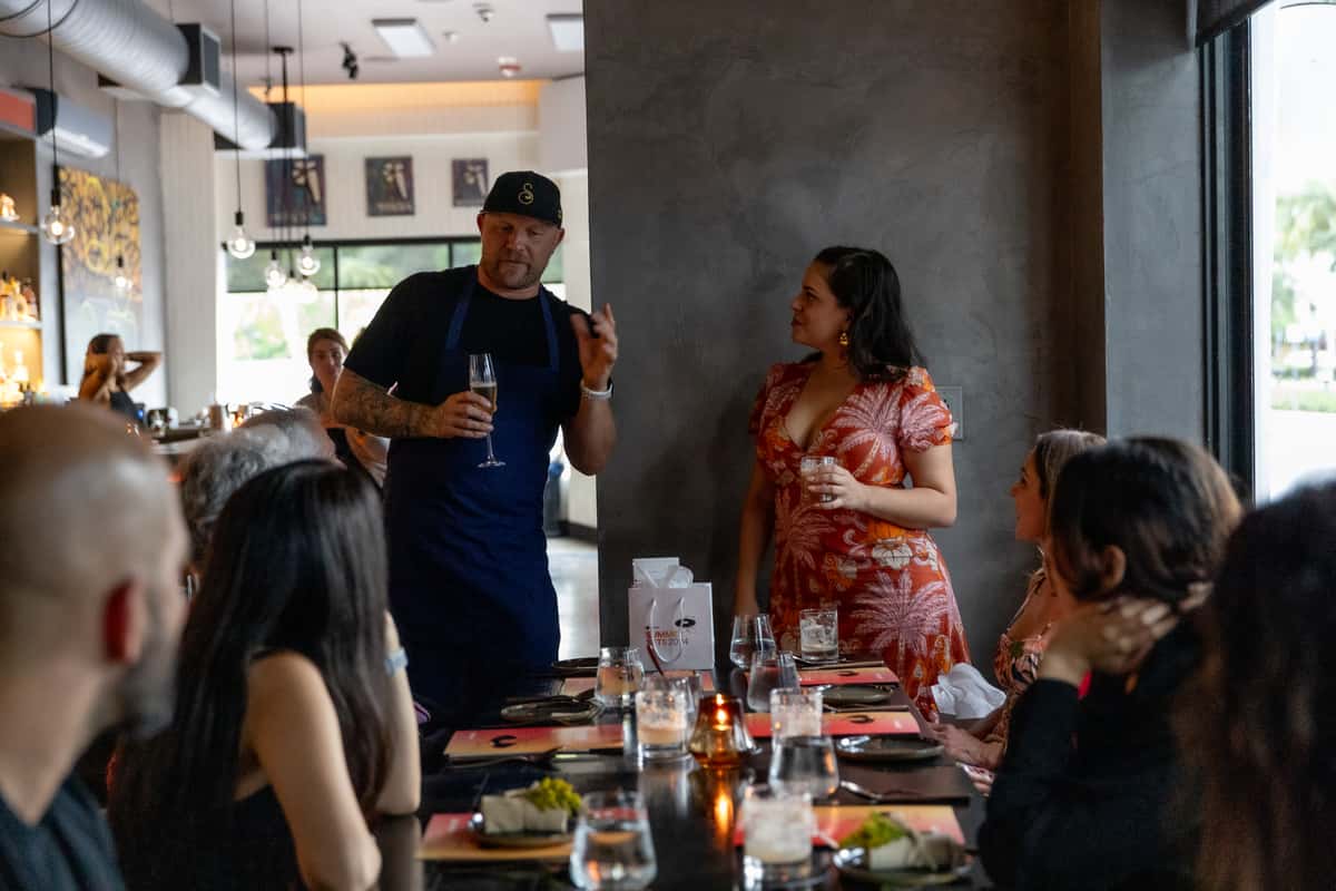 Chef speaking with guests during a guided fine dining wine experience