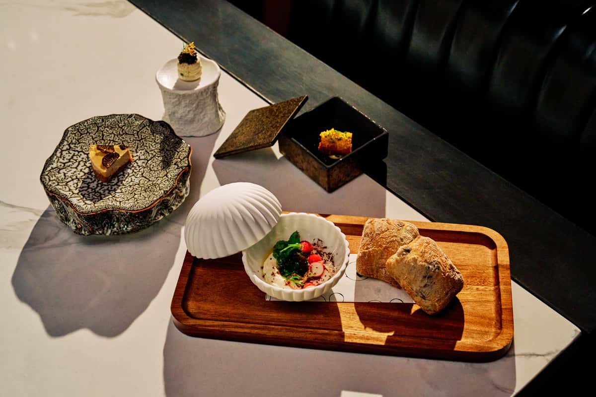 Fine dining appetizer and dessert presentation with artistic plated dishes on a restaurant table