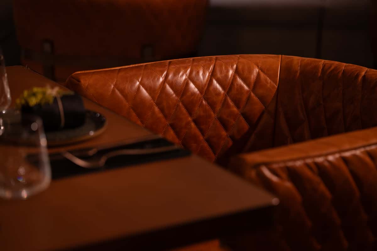 Quilted leather dining chair highlighting premium seating and warm restaurant materials