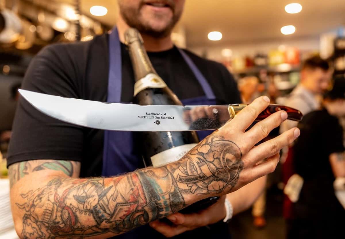 Restaurant staff member holding a knife engraved with Stubborn Seed Michelin One Star 2024