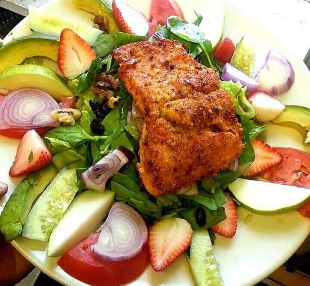 salad topped with chicken breast