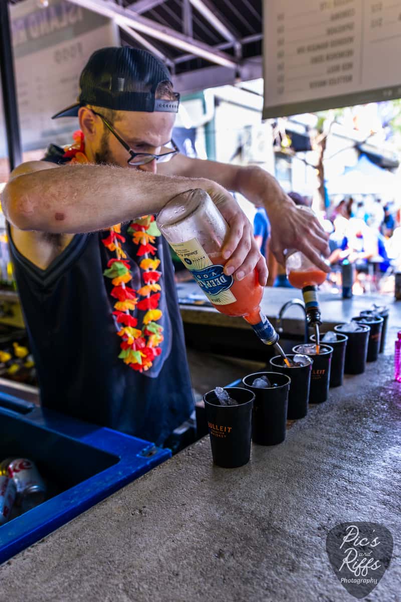 Bartender pouring festival cocktails at Island Rock Fest